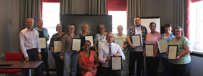 Cleaning and Catering colleagues being presented their leadership course award