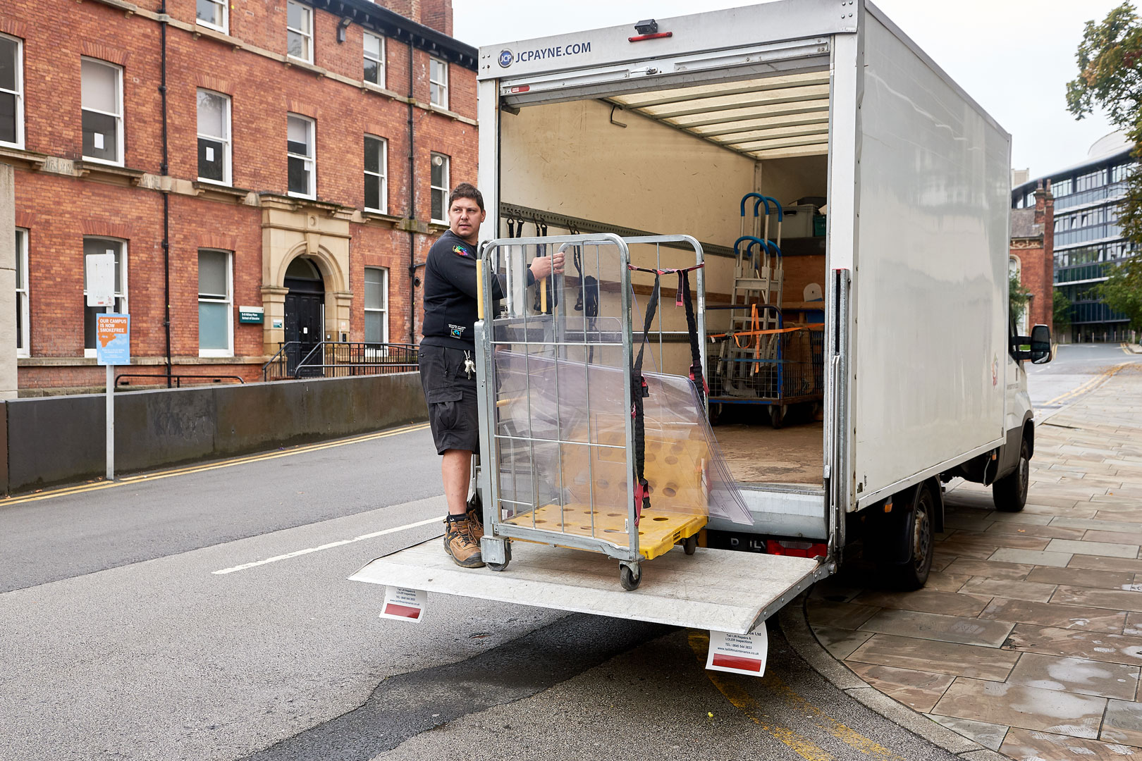 Employee moving equipment from truck